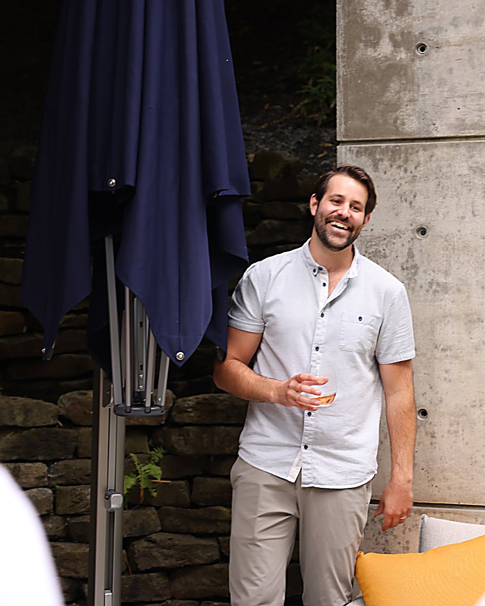 Nicholas Lagassé, founder of Tégō Shade, smiling beside a Shadowspec umbrella at a client demonstration