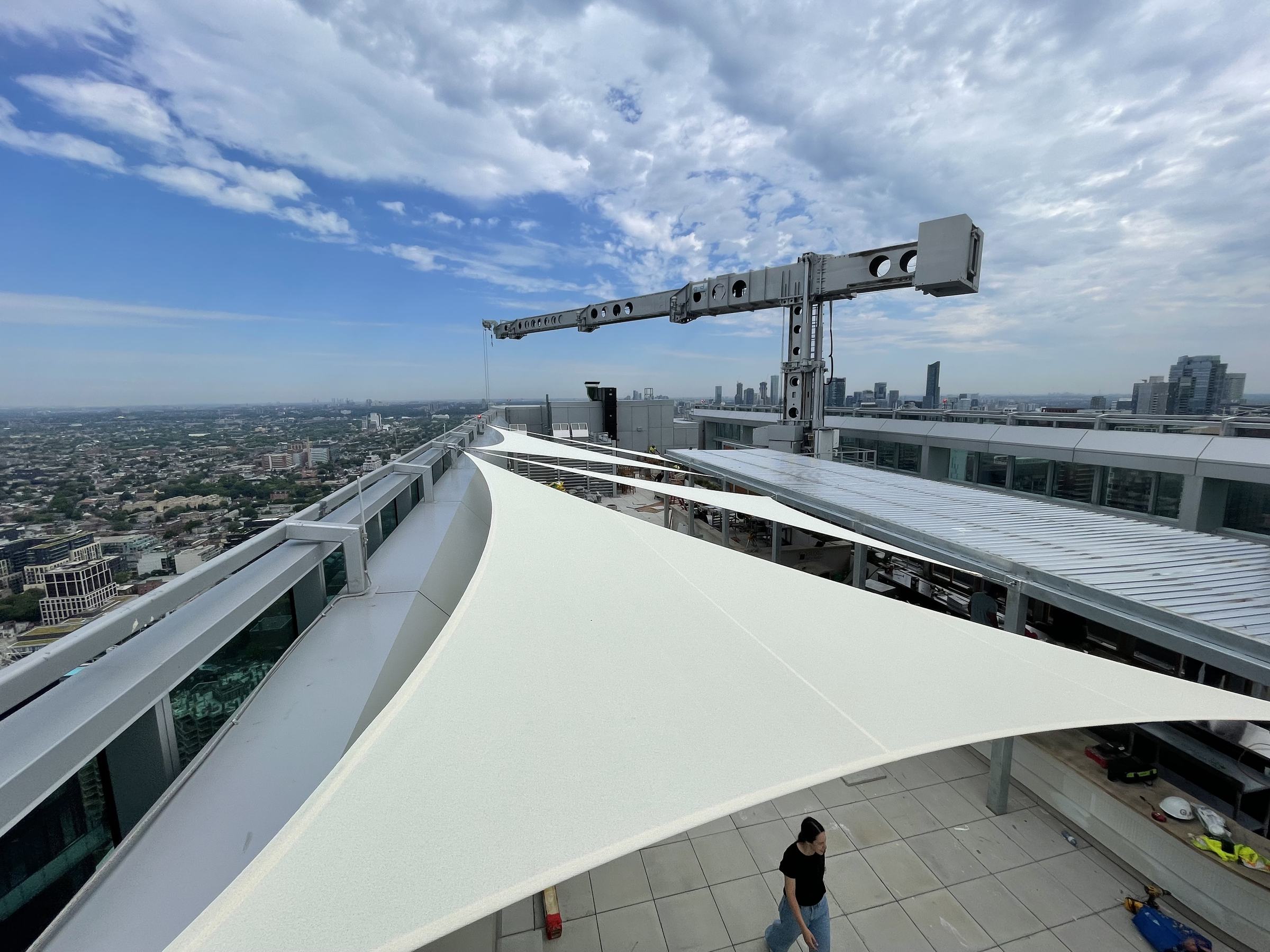 Several shade sails over the rooftop patio at Aera at The Well, Toronto
