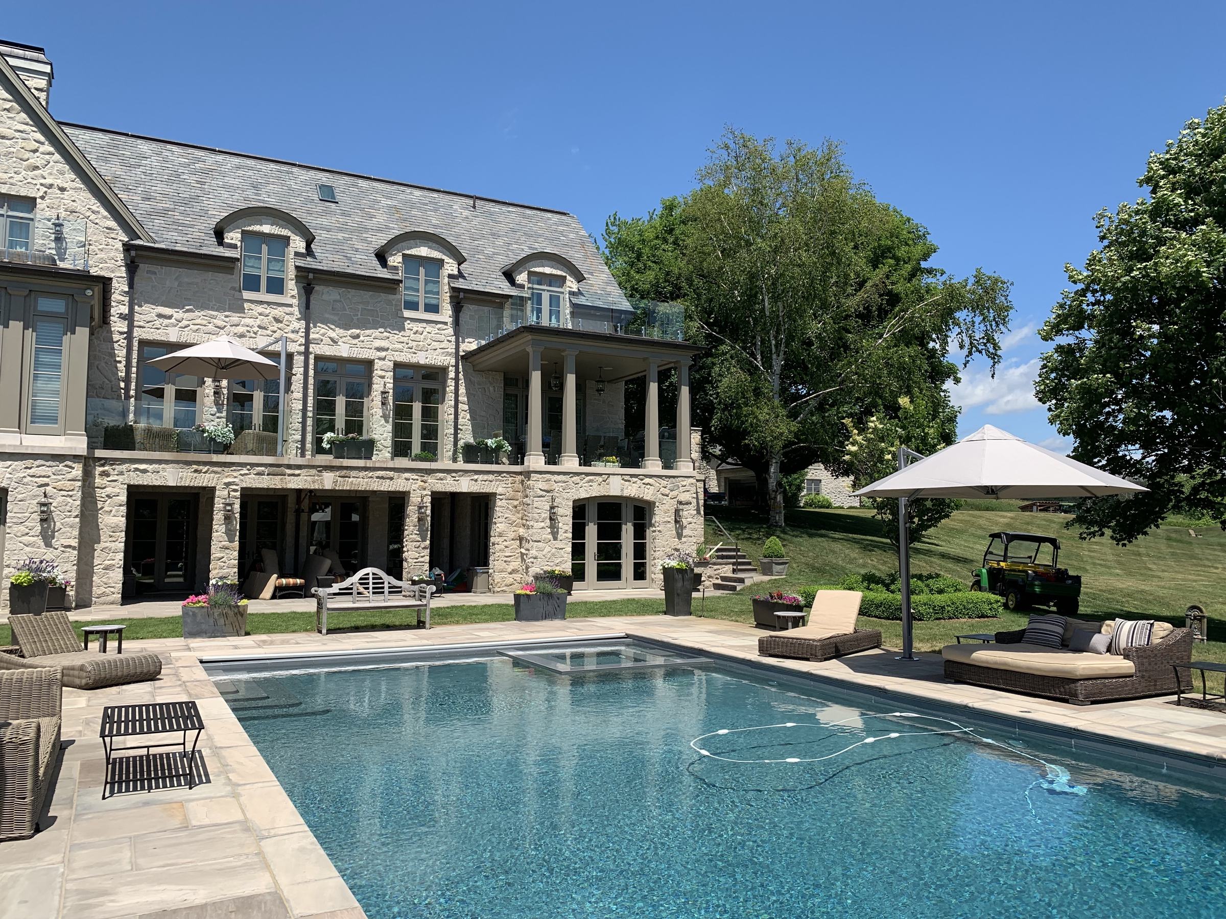 Shadowspec Serenity umbrellas around the pool at Caledon Estate, Ontario