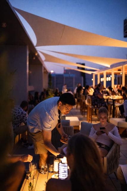 Evening service under the shade sails at Aera at The Well, Toronto